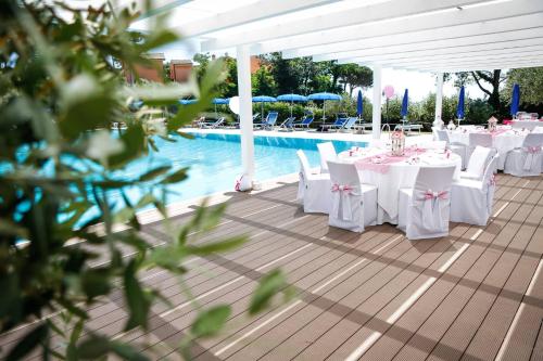 a group of tables and chairs next to a pool at Agriturismo La Molara in Sessa Aurunca