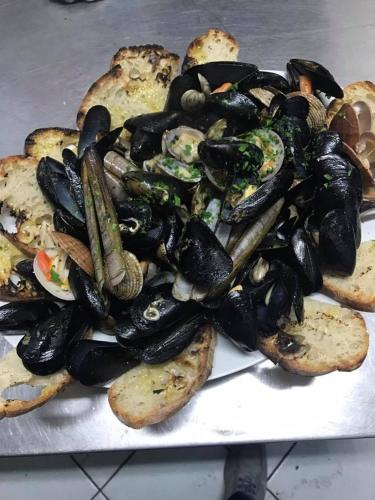 a pile of mussels and bread on a table at Agriturismo La Molara in Sessa Aurunca