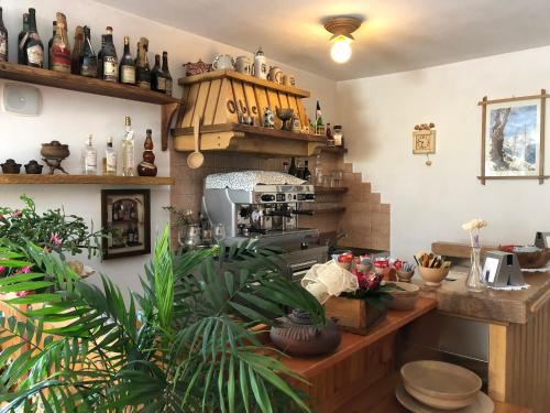 a kitchen with lots of bottles on the wall at Residence Oberteil in Gressoney-la-Trinité