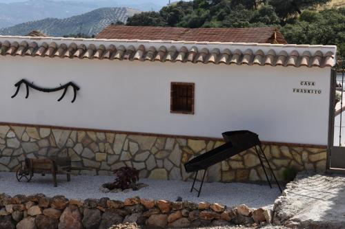 a building with a black spider on the side of it at Casa Fraskito in Iznájar