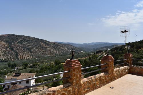 a balcony with a view of a mountain at Casa Fraskito in Iznájar