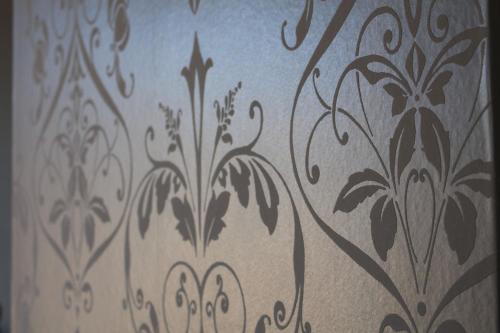 a curtain with a floral pattern on a wall at Highfield Guest House in Edinburgh