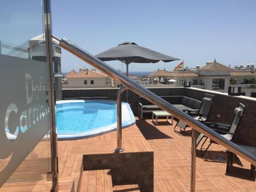 a swimming pool on a balcony with an umbrella at Hostal Boutique Doña Carmen - Adults Recommended in Nerja