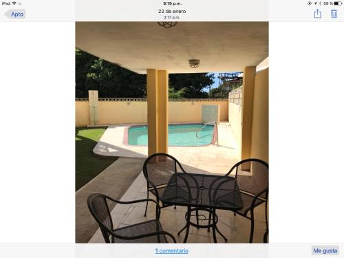 a patio with two chairs and a swimming pool at Boqueron vacation in Boqueron