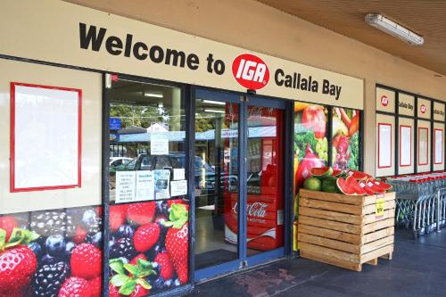 a store front of a store with fruits and vegetables at Sandy Toes Beach House Jervis Bay - 2min to Beach in Callala Beach