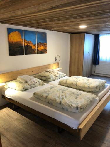 a bedroom with two beds in a room at Hotel Restaurant Simplon in Frutigen