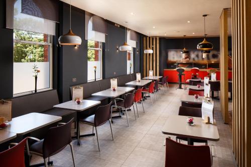 
a restaurant with tables and chairs in it at ibis Coventry Centre in Coventry
