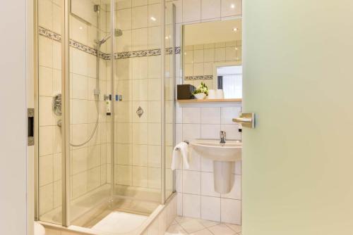 a bathroom with a shower and a sink at Hotel Restaurant Sonne in Gengenbach