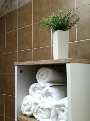 a pile of towels on a shelf in a bathroom at Apartman Ivana in Varaždin