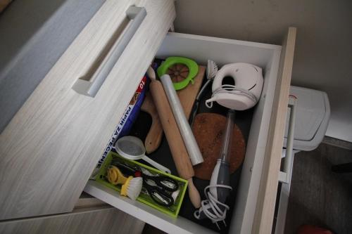 a cupboard filled with lots of kitchen utensils at Apartment G10 Milmari resort in Kopaonik