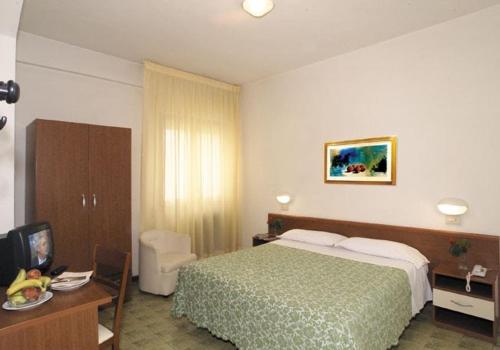アッバディーア・サン・サルヴァトーレにあるHotel Ristorante Giardinoのベッドルーム1室(ベッド1台、デスク、テレビ付)