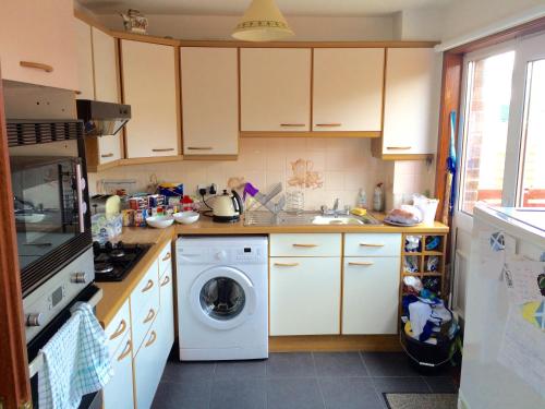 a kitchen with a washing machine and a washer at Inverkenny House in Inverness