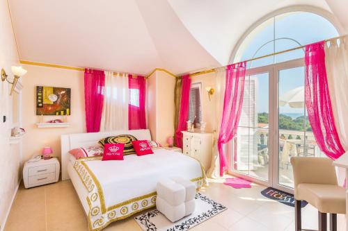 a bedroom with a bed and a large window at Apartments Lucie in Premantura