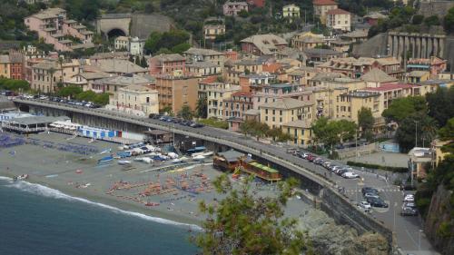 a city with a bridge over a beach with cars at Albergo Lungomare in Bonassola
