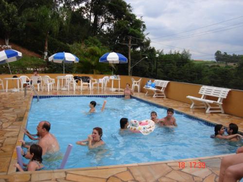 a group of people in a swimming pool at Residencia Pereira in Serra Negra