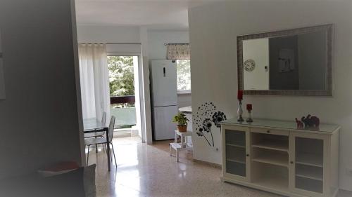 a living room with a table and a mirror at La Castillo in Santa Cruz de Tenerife