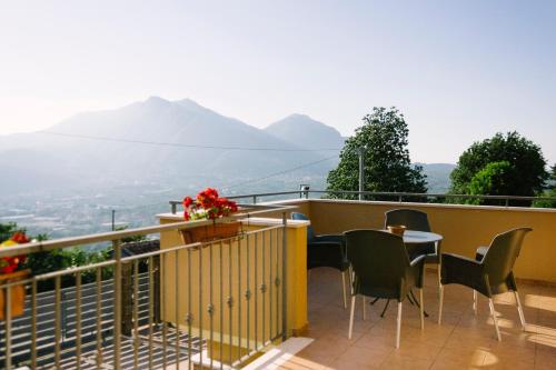 a balcony with a table and chairs and mountains at Villa Amalia in Avellino