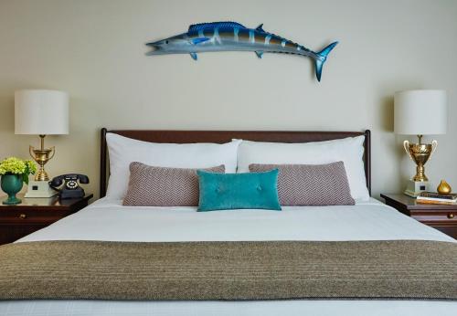 a bedroom with a bed with a blue fish above it at Graduate by Hilton Charlottesville in Charlottesville