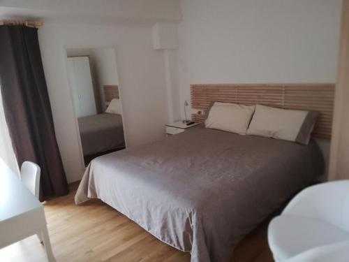 a bedroom with a bed and a chair and a mirror at Agriturismo Masseria Cannella in Lesina