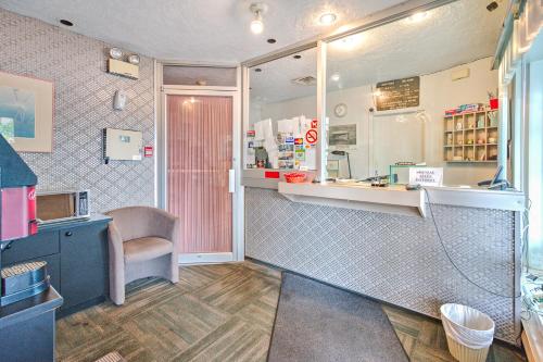 a small kitchen with a counter and a sink at Motel R-100 in Longueuil