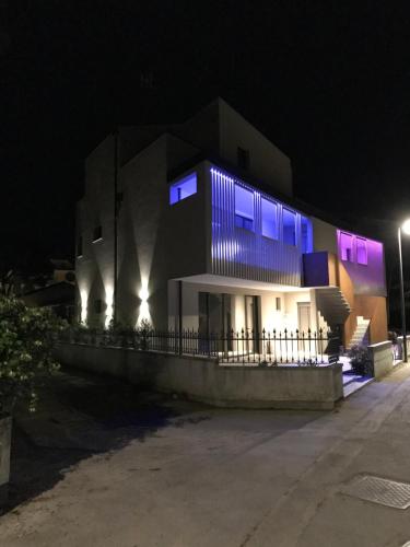 a building with purple lights on it at night at Villa Alcova in Caorle