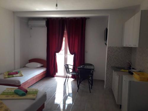 a room with a bed and a table and a window at Apartmani Andrea-jaz in Budva