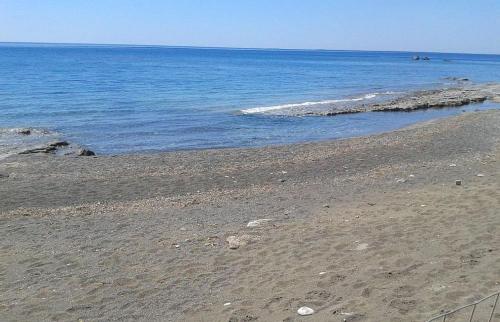 an empty beach with the ocean in the background at Villa Pelagos in Koutsounari