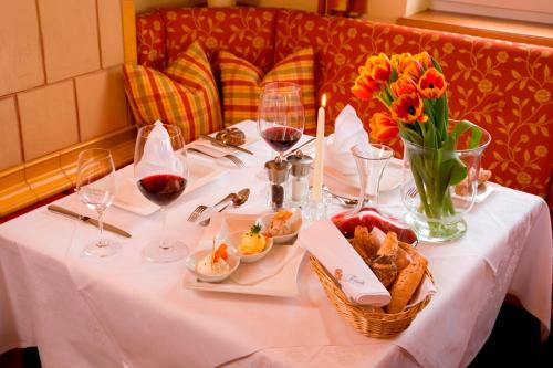 a table with wine glasses and a basket of food at Hotel Wachau in Melk