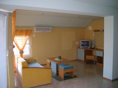 a living room with a couch and a table at Dari Guest Rooms Стаи за гости Дари in Nesebar