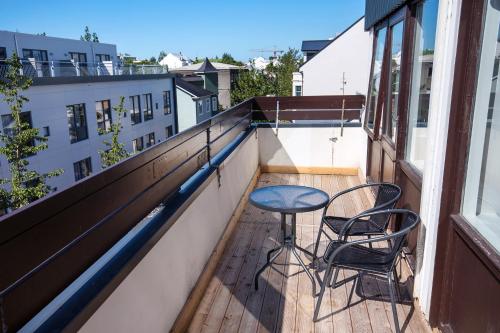 a balcony with two chairs and a table on a balcony at Svala Apartments by Heimaleiga in Reykjavík