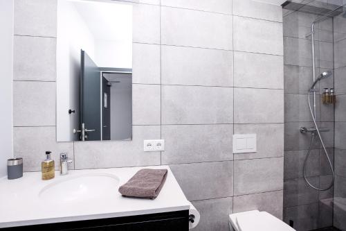 a bathroom with a sink and a shower at Svala Apartments by Heimaleiga in Reykjavík