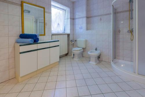 a bathroom with a toilet and a sink and a shower at Two-Bedroom Apartment in Crikvenica VI in Sopaljska