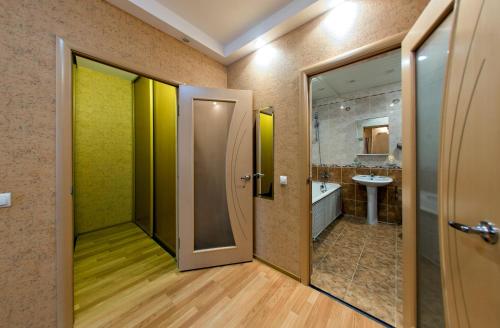 a bathroom with a shower and a toilet and a sink at SutkiUfa Рихарда Зорге 70/2.1 in Ufa