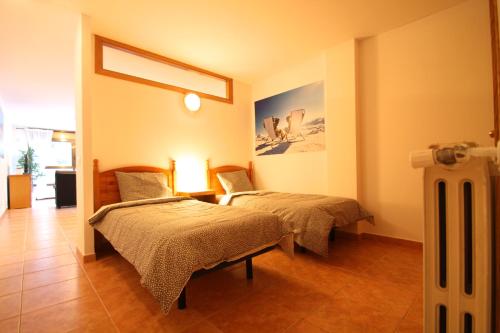 a room with two beds and a radiator at Pont de Toneta 2,1 Ransol, Zona Grandvalira in Ransol