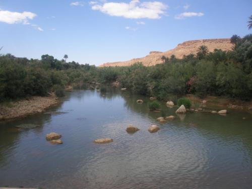 a river with some rocks in the water at Gite Tamlli in Aoufous