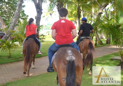 a group of people riding horses down a path at Hotel Atlantis in Las Terrenas