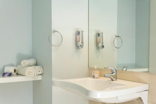 a bathroom with a sink and a mirror at Circus Hostel in Buenos Aires