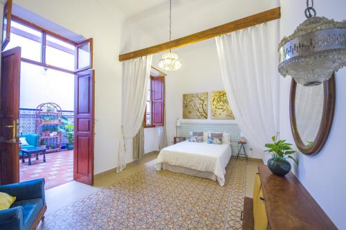a bedroom with a white bed and a large window at Aminta Home in Las Palmas de Gran Canaria