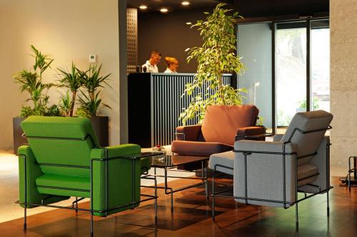 a lobby with chairs and a table and people at Lifestyle Hotel Vitar - Adults Only in Bol