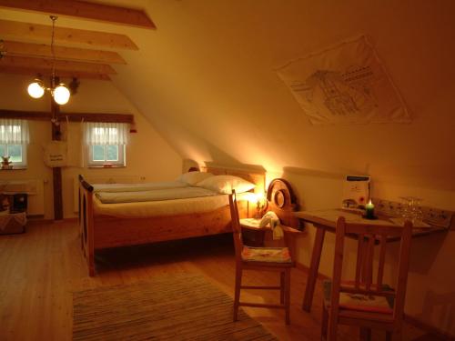 a bedroom with a bed and a table at Sonnenhaus Grandl in Feldbach