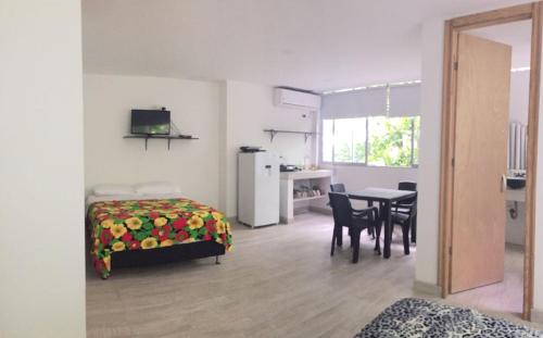 um quarto com uma cama e uma mesa com cadeiras em Casona La Carolina em San Andrés