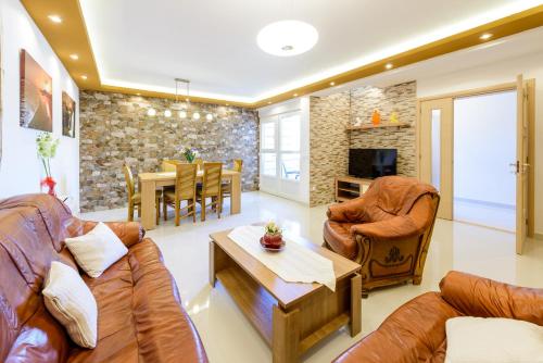 a living room with two couches and a table at Luxury Apartments in Dubrovnik
