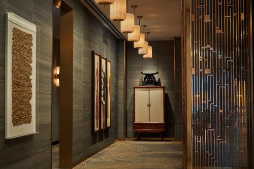 a hallway with a wall with a patterned wall at Viceroy Chicago in Chicago