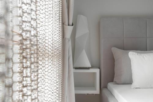 a bedroom with a bed and a white curtain at "Comfort Stay" - Juodkrante in Juodkrantė