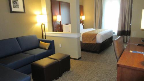 a hotel room with a bed and a couch at Comfort Inn & Suites Boise Airport in Boise