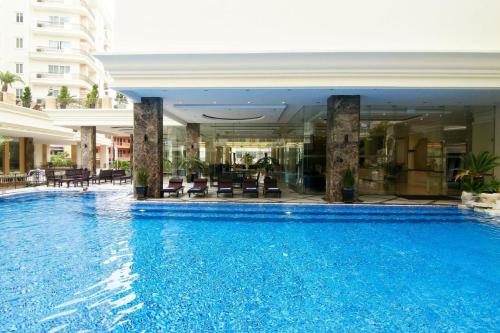 a large swimming pool in the middle of a building at LK Miracle Suite - SHA Extra Plus in Pattaya South