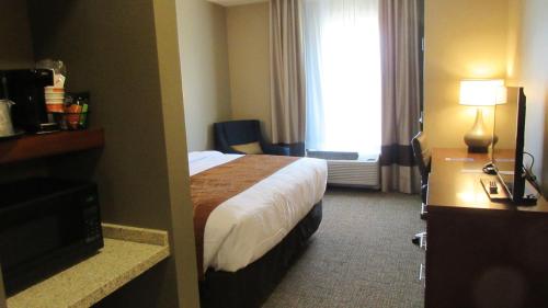 a hotel room with a bed and a window at Comfort Inn & Suites Boise Airport in Boise