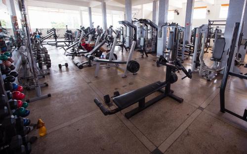 a gym with a lot of treadmills and machines at Hotel Holliday in Macapá