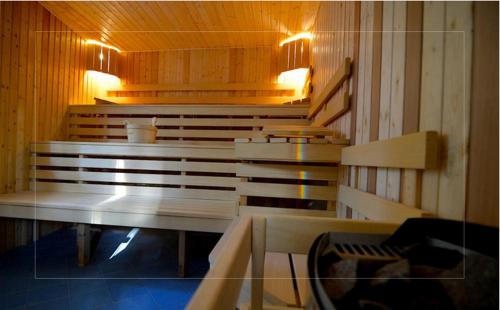 a row of benches in a room with lights at Hotel EUROPA - Górnicza Strzecha in Szklarska Poręba