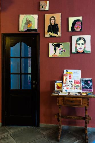a room with a red wall with pictures on the wall at Boutique Hotel Justus in Rīga